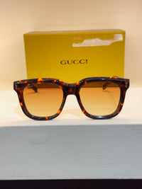 Gucci carrée au motif écaille brun et ambré, avec verres jaune-orangé — photo réelle 1 de la paire chez NVL